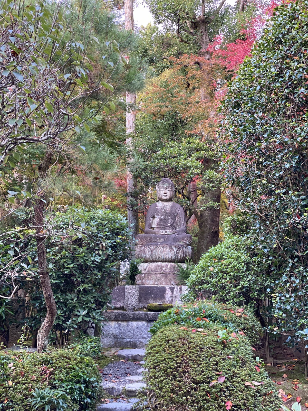 A weathered stone Jizo statue in the moss garden at Nanzen-ji in Kyoto, Japan, photographed by Lee Hnetinka